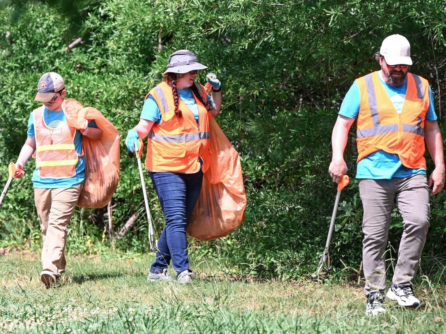 Creek Cleanup volunteers in high vis vests pick up trash