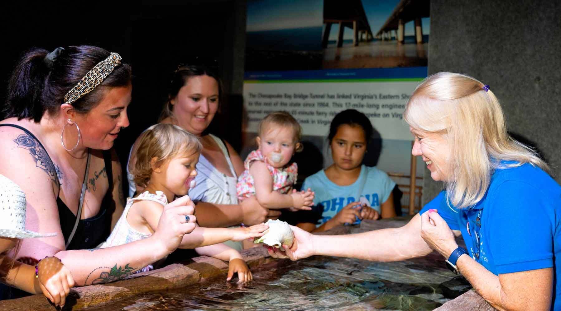 Volunteer Showing Shells to Children