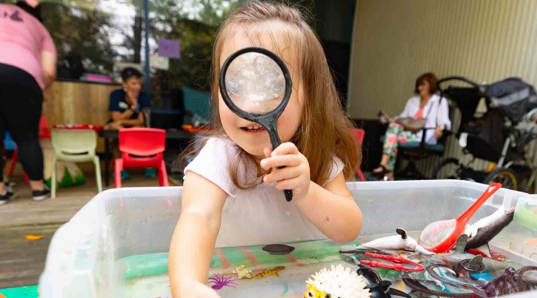 Child with Magnifine Glass